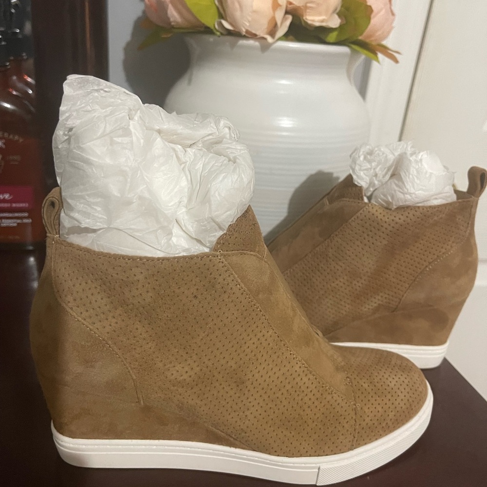 sleek modern wedge bootie with sophisticated lines, luxe materials. Size 5 1/2